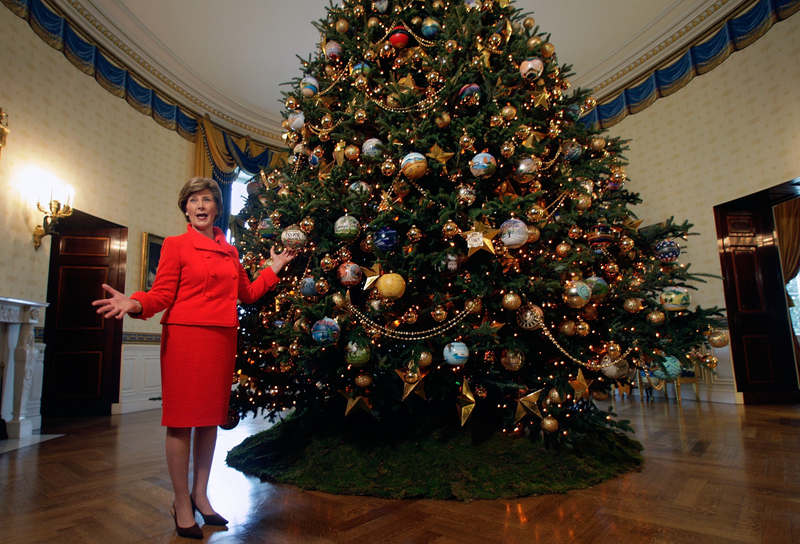 Illustration for article titled 70 Years of First Ladies Standing in Front of Christmas TreesÂ